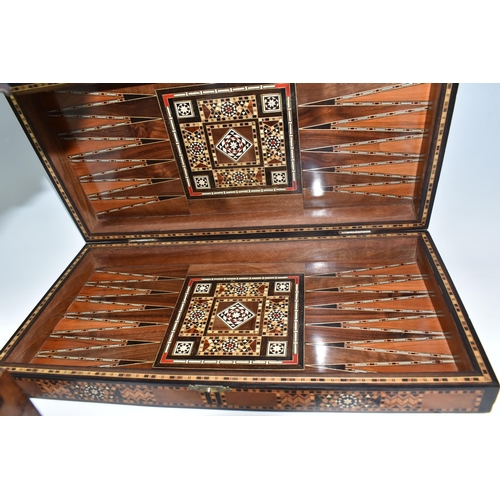 505 - TWO MIDDLE EASTERN BACKGAMMON BOARDS, comprising a large 1970's inlaid games box with chess board to... 