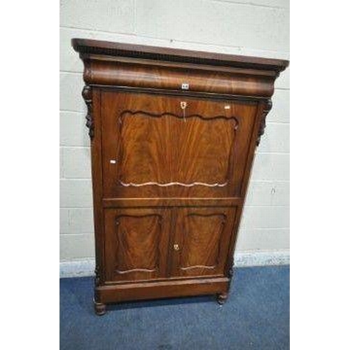 1197 - A VICTORIAN MAHOGANY ESCRITOIRE, with a single drawer, the fall front door enclosing a fitted interi... 