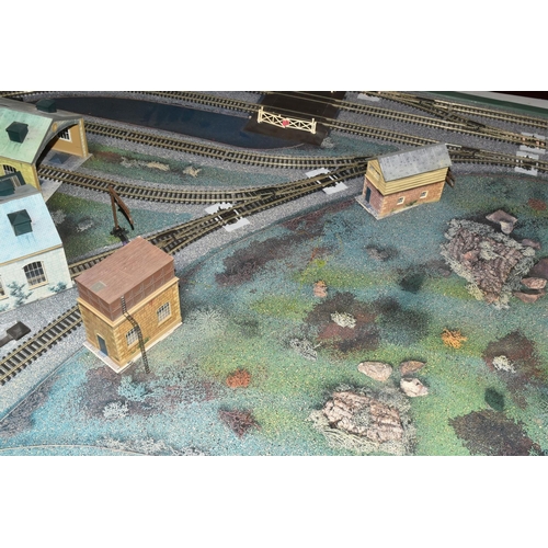 160 - A OO GAUGE MODEL RAILWAY LAYOUT, hardboard base supported on timber battens and edged in timber to w... 