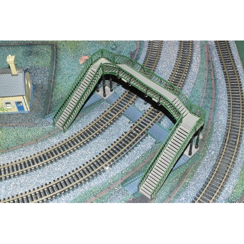 160 - A OO GAUGE MODEL RAILWAY LAYOUT, hardboard base supported on timber battens and edged in timber to w... 