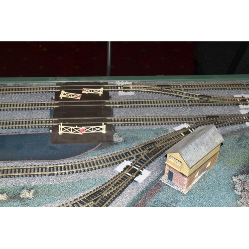 160 - A OO GAUGE MODEL RAILWAY LAYOUT, hardboard base supported on timber battens and edged in timber to w... 