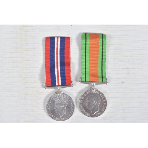 270 - TWO WWII MEDALS AND A SMALL AMOUNT OF COINS, the medals consist of a 1939-1945 war medal and a defen... 