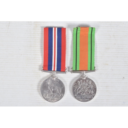 270 - TWO WWII MEDALS AND A SMALL AMOUNT OF COINS, the medals consist of a 1939-1945 war medal and a defen... 