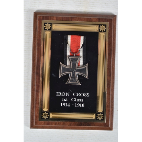 273 - A WWI GERMAN IRON CROSS AND TWO BRASS SHELLS, the Iron Cross has a magnetic centre and is attached t... 