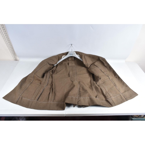 333 - A VINTAGE SUITCASE CONTAINING A QUANTITY OF DRESS UNIFORMS, these include a size 22 Royal Marines ja... 