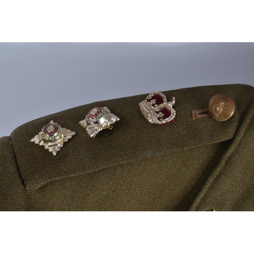 333 - A VINTAGE SUITCASE CONTAINING A QUANTITY OF DRESS UNIFORMS, these include a size 22 Royal Marines ja... 