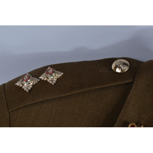 333 - A VINTAGE SUITCASE CONTAINING A QUANTITY OF DRESS UNIFORMS, these include a size 22 Royal Marines ja... 