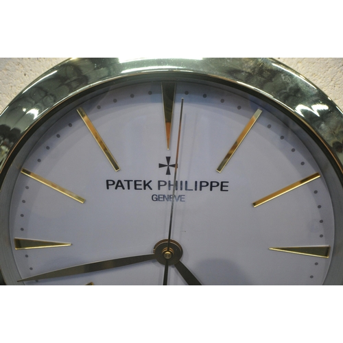 1201 - A PATEK PHILIPPE GENEVE DEALERS ADVERTISING WALL CLOCK, with a brassed frame, and a grey dial, diame... 