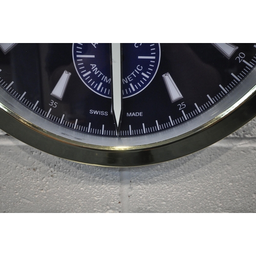 1205 - A VACHERON CONSTANTIN GENEVE DEALERS ADVERTISING WALL CLOCK, with a brassed frame, and a dark blue d... 