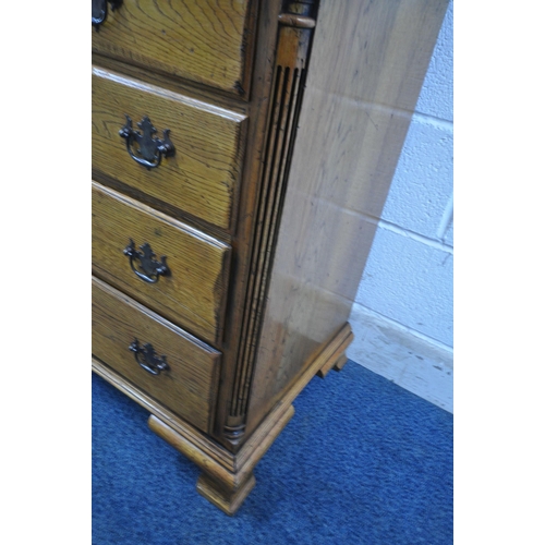 1208 - A 20TH CENTURY GEORGIAN STYLE OAK CHEST OF TWO SHORT OVER THREE LONG DRAWERS, with reeded front corn... 