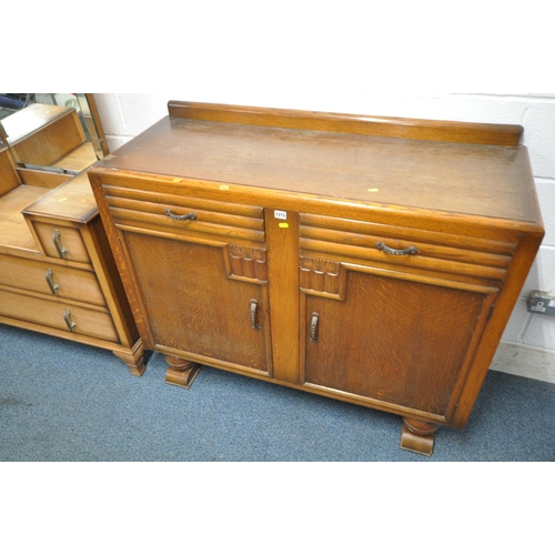 1215 - AN EARLY 20TH CENTURY OAK SIDEBOARD, with a raised back, fitted with two drawers, above double cupbo... 