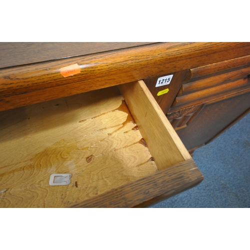 1215 - AN EARLY 20TH CENTURY OAK SIDEBOARD, with a raised back, fitted with two drawers, above double cupbo... 