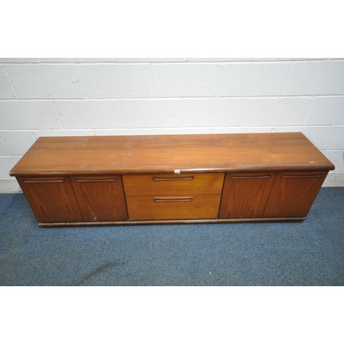 1216 - A MID CENTURY PROGRAM TEAK SIDEBOARD, fitted with four cupboard doors, flanking two drawers, length ... 