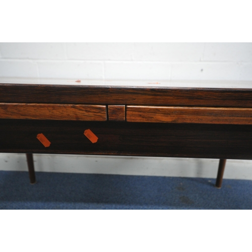 1233 - A MID CENTURY DANISH ROSEWOOD DRAW LEAF DINING TABLE, raised on cylindrical tapered legs, extended l... 