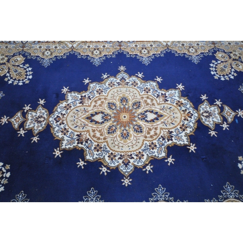 1236 - A BLUE GROUND RECTANGULAR WOOLLEN RUG, with a central medallion, repeating foliate patterns, surroun... 