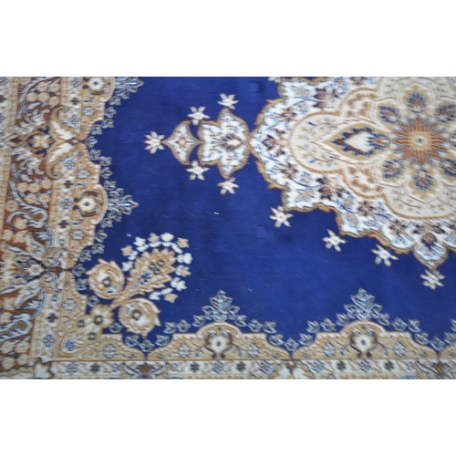 1236 - A BLUE GROUND RECTANGULAR WOOLLEN RUG, with a central medallion, repeating foliate patterns, surroun... 