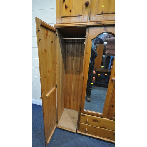 1250 - A MODERN PINE TRIPLE DOOR WARDROBE, with a three door section to the top, a central mirrored door, a... 