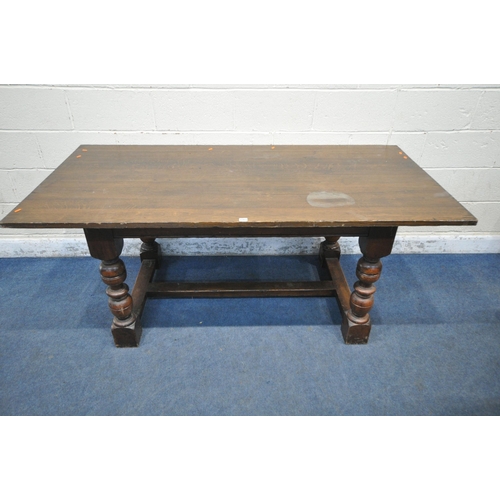 1263 - A 20TH CENTURY SOLID OAK RECTANGULAR TABLE, raised on block and turned legs, united by a stretcher, ... 