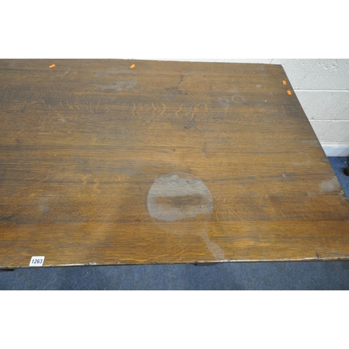 1263 - A 20TH CENTURY SOLID OAK RECTANGULAR TABLE, raised on block and turned legs, united by a stretcher, ... 