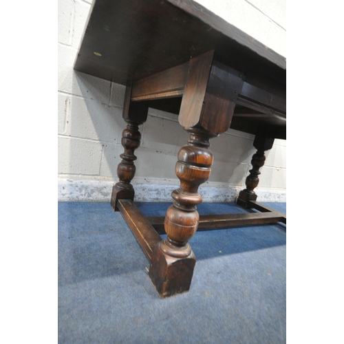 1263 - A 20TH CENTURY SOLID OAK RECTANGULAR TABLE, raised on block and turned legs, united by a stretcher, ... 