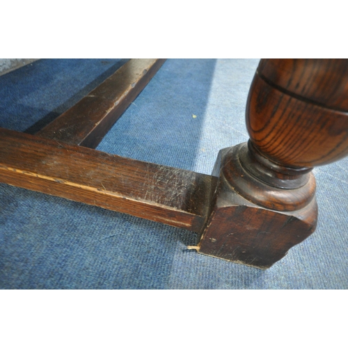 1263 - A 20TH CENTURY SOLID OAK RECTANGULAR TABLE, raised on block and turned legs, united by a stretcher, ... 