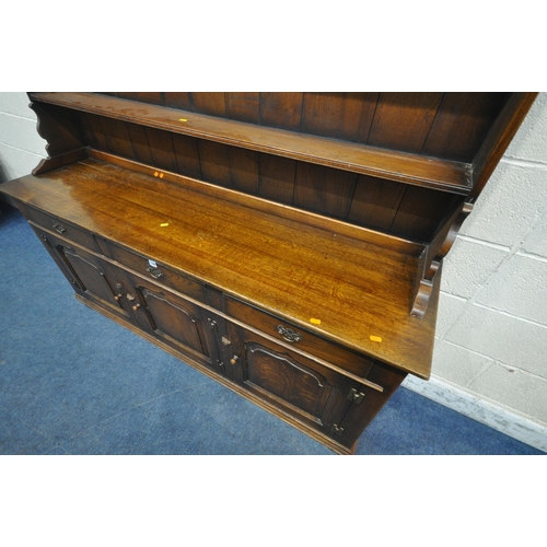 1266 - IN THE MANNER OF TITCHMARSH AND GOODWIN, A 20TH CENTURY SOLID OAK DRESSER, the three tier plate rack... 