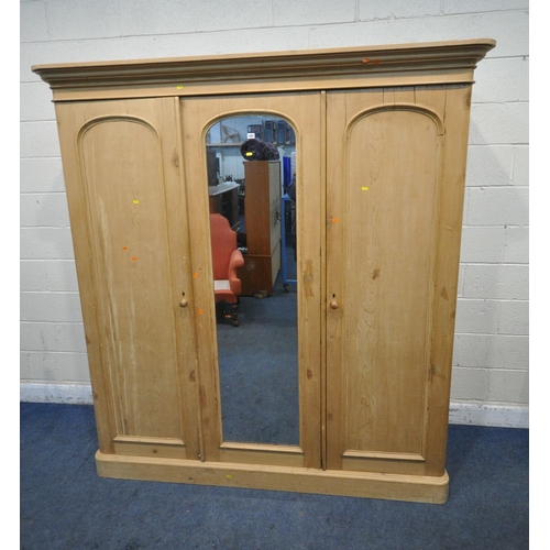 1267 - A 19TH CENTURY PINE TRIPLE DOOR WARDROBE, with an overhanging cornice, a central mirror door, the ri... 