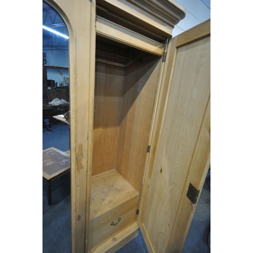 1267 - A 19TH CENTURY PINE TRIPLE DOOR WARDROBE, with an overhanging cornice, a central mirror door, the ri... 