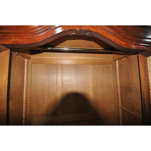 1297 - A 19TH CENTURY FRENCH FLAME MAHOGANY TWO DOOR WARDROBE, with bevelled edge mirror doors, enclosing a... 