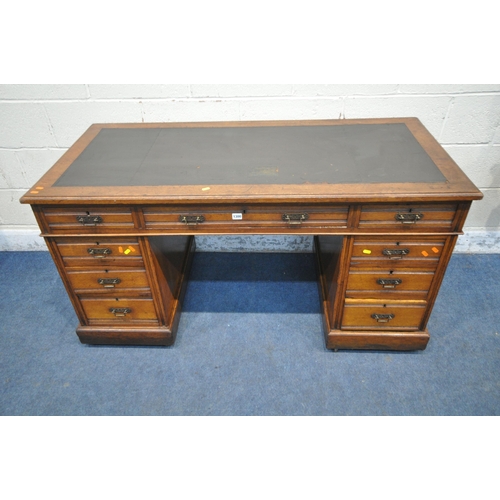 1300 - A 20TH CENTURY OAK TWIN PEDESTAL DESK, with a leatherette writing surface, fitted with nine assorted... 