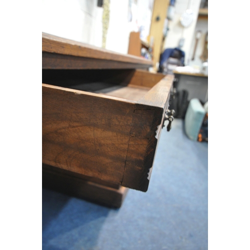 1300 - A 20TH CENTURY OAK TWIN PEDESTAL DESK, with a leatherette writing surface, fitted with nine assorted... 