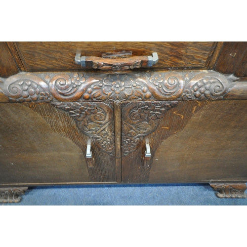 1306 - A 20TH CENTURY OAK SIX PIECE LOUNGE SUITE, comprising a draw leaf dining table, with a carved apron,... 