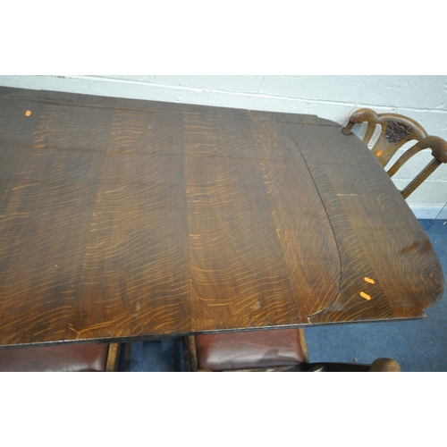 1306 - A 20TH CENTURY OAK SIX PIECE LOUNGE SUITE, comprising a draw leaf dining table, with a carved apron,... 