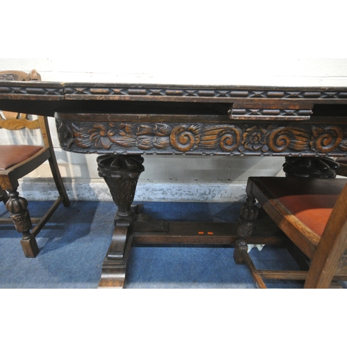 1306 - A 20TH CENTURY OAK SIX PIECE LOUNGE SUITE, comprising a draw leaf dining table, with a carved apron,... 