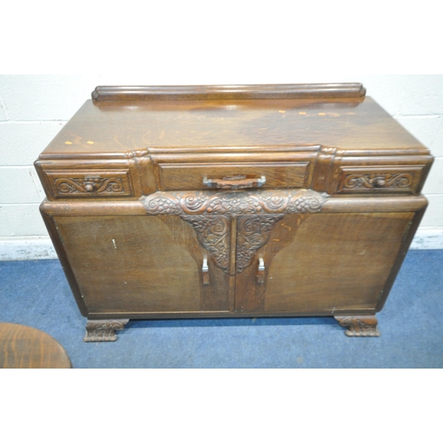 1306 - A 20TH CENTURY OAK SIX PIECE LOUNGE SUITE, comprising a draw leaf dining table, with a carved apron,... 