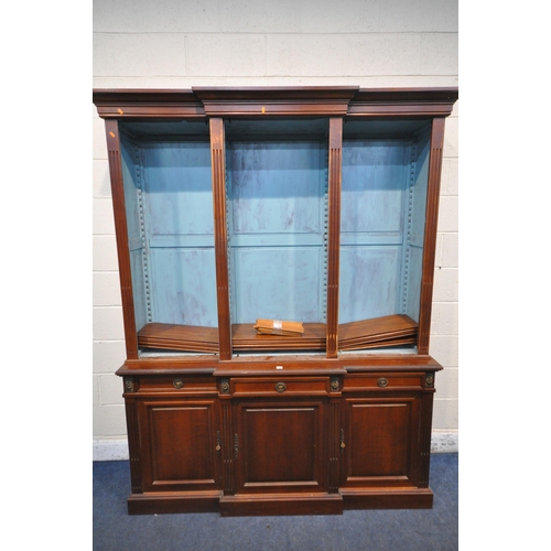 1325 - A REPRODUCTION MAHOGANY BREAKFRONT BOOKCASE, the open triple section top with a blue painted interio... 