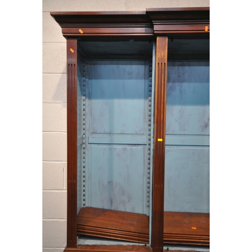 1325 - A REPRODUCTION MAHOGANY BREAKFRONT BOOKCASE, the open triple section top with a blue painted interio... 