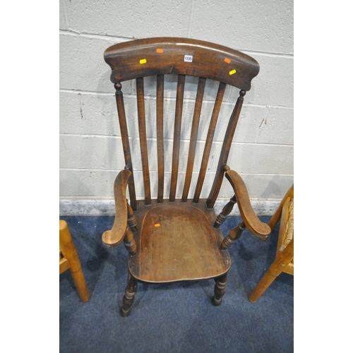 1335 - A 20TH CENTURY OAK ARMCHAIR, with swept armrests, raised on turned legs, united by stretchers, along... 