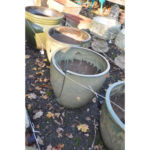 1024 - A SELECTION OF GREEN GLAZED PLANT POTS, including a set of three 46cm in diameter with an overlappin... 