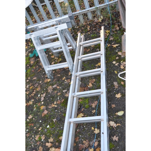 1031 - AN ALUMINIUM DOUBLE EXTENSION LADDER, with 13 rungs to each 390cm section and a folding platform lad... 