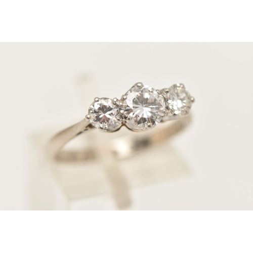 1 - A WHITE AND YELLOW METAL DIAMOND THREE STONE RING, set with graduating round brilliant cut diamonds,... 