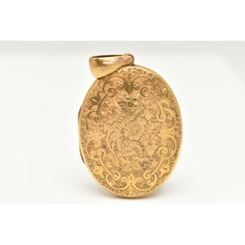 13 - A LARGE YELLOW METAL OVAL LOCKET, detailed with a floral and ivy leaf pattern with vacant cartouche,... 