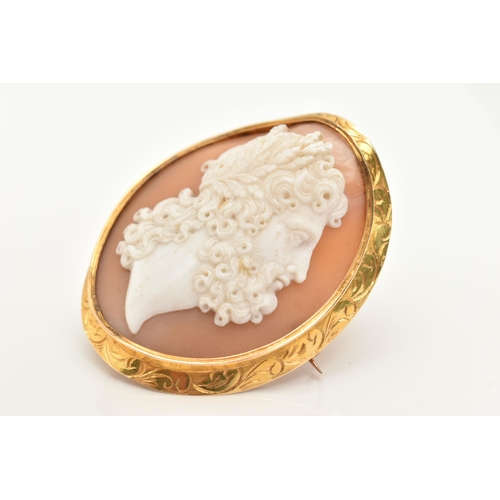 15 - A YELLOW METAL CAMEO BROOCH, of an oval form, carved shell cameo depicting a Grecian man, collet set... 