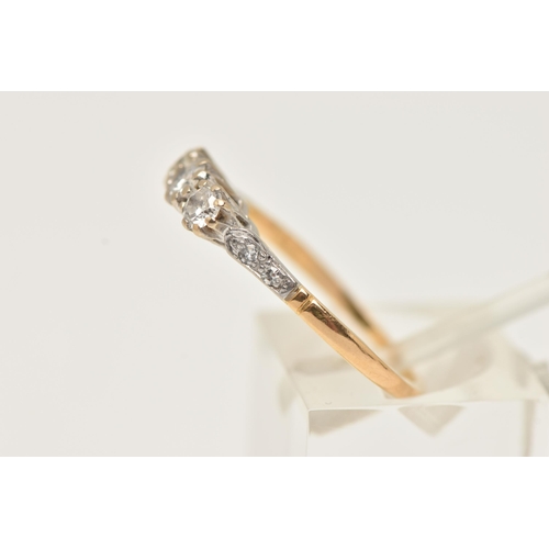 2 - A WHITE AND YELLOW METAL DIAMOND THREE STONE RING, set with slightly graduating round brilliant cut ... 