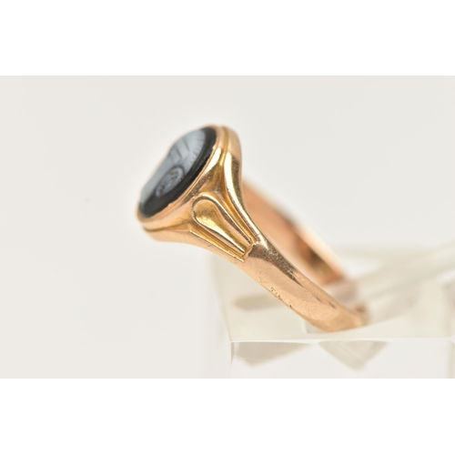 26 - A YELLOW METAL SARDONYX RING, of an oval form with a black and white sardonyx cameo, collet set to t... 