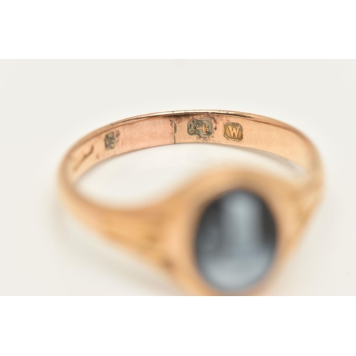 26 - A YELLOW METAL SARDONYX RING, of an oval form with a black and white sardonyx cameo, collet set to t... 