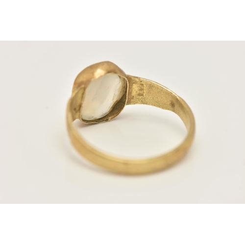 32 - A YELLOW METAL QUARTZ RING, set with a quartz cabochon stone, rough collet set to textured shoulders... 