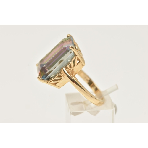 42 - A YELLOW METAL LARGE MYSTIC TOPAZ DRESS RING, set with a large rectangular cut mystic topaz, measuri... 