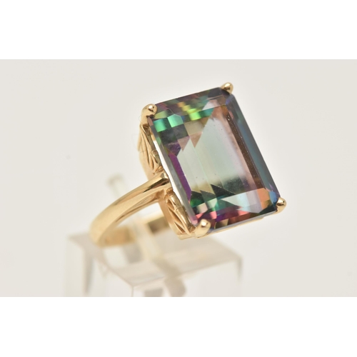 42 - A YELLOW METAL LARGE MYSTIC TOPAZ DRESS RING, set with a large rectangular cut mystic topaz, measuri... 