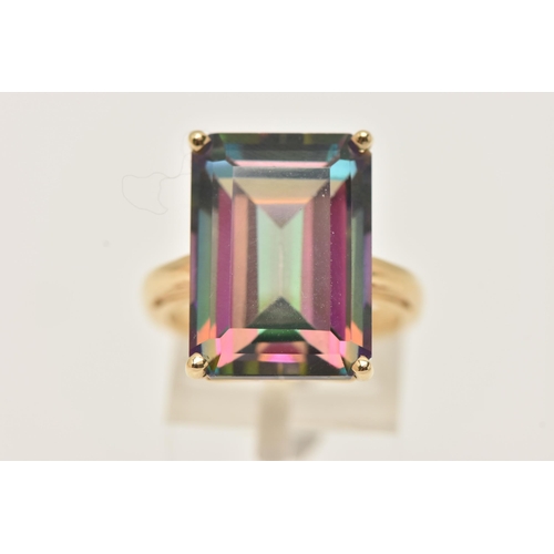 42 - A YELLOW METAL LARGE MYSTIC TOPAZ DRESS RING, set with a large rectangular cut mystic topaz, measuri... 